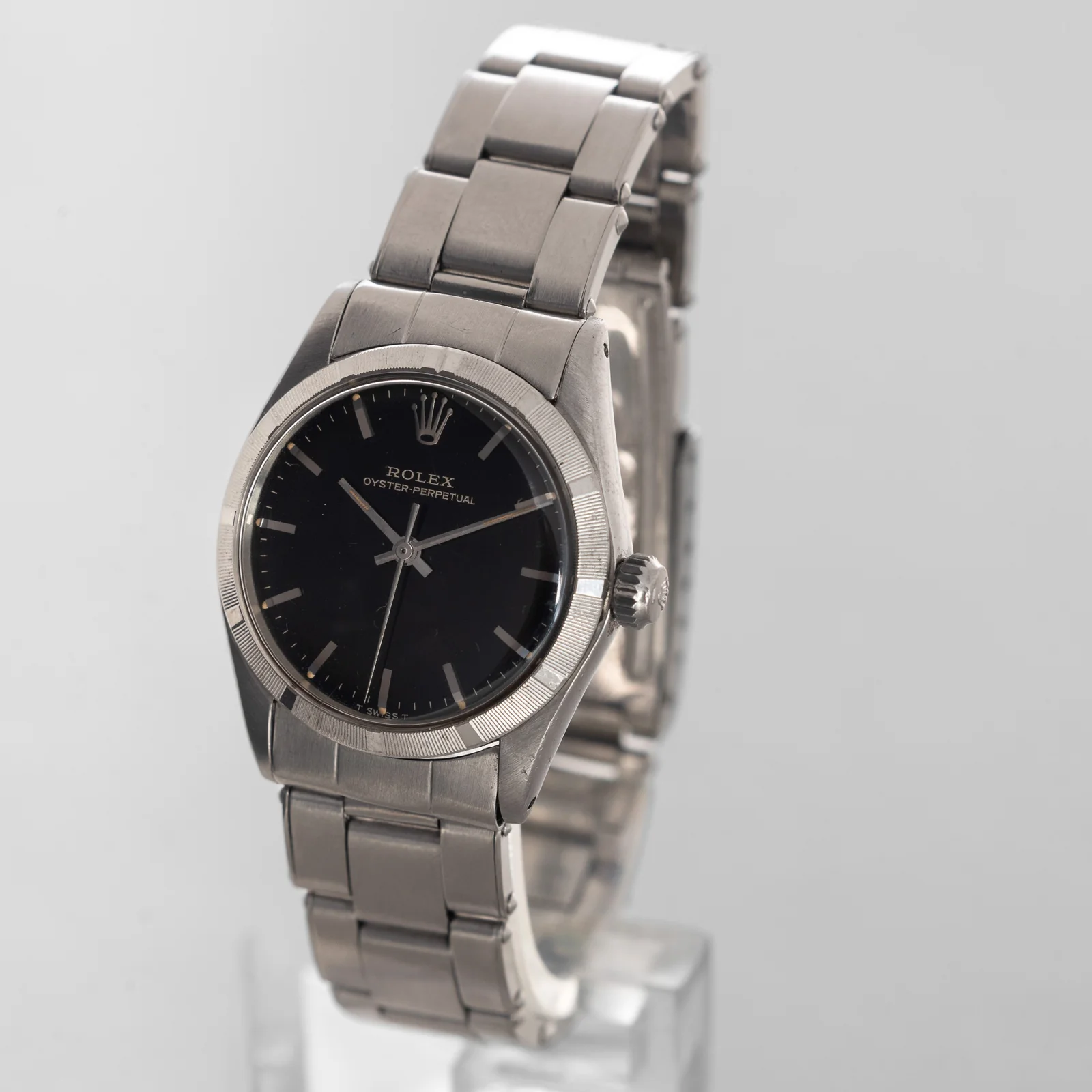 Oblique view of the black gilt dial, engine-turned bezel and crown on a Rolex 6549