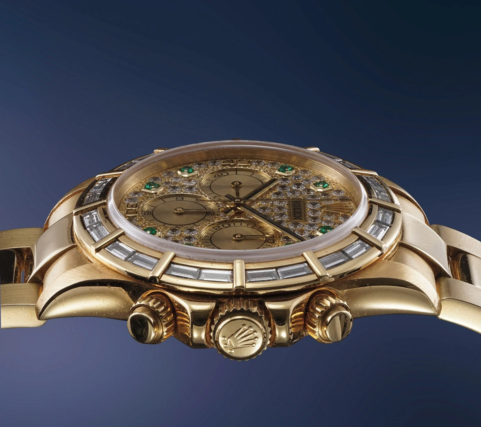 Side view of the yellow-gold Rolex Daytona 16568 showing the crown, screw-down pushers, case and gem-set bezel