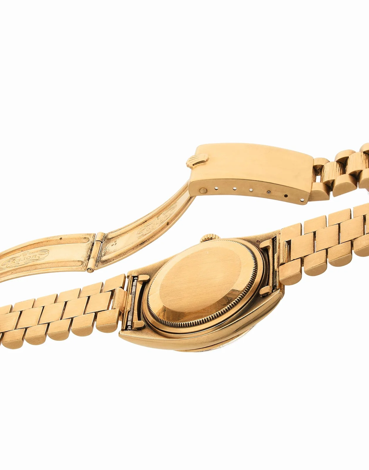 Underside of a gold Datejust bracelet, clasp, and caseback