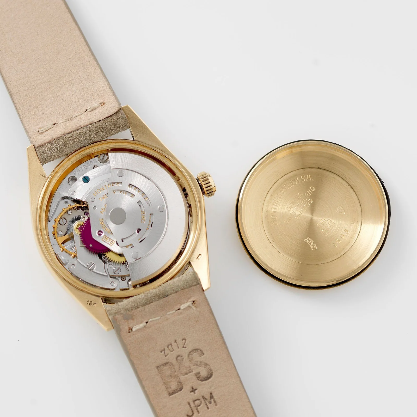 Open back of a gold Rolex Date showing a movement marked 1570