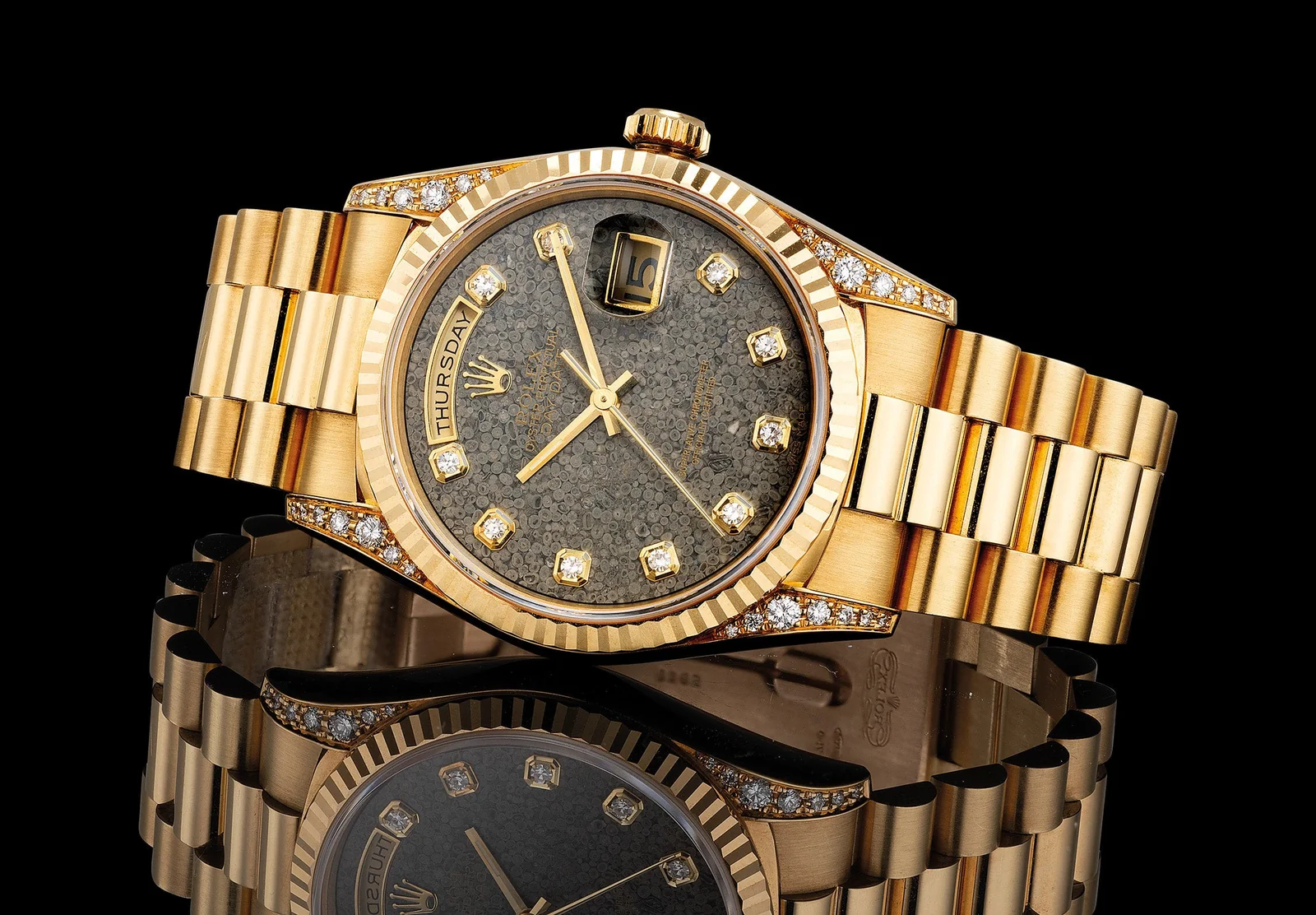 Angled view of yellow-gold Rolex Day-Date 18338 with fossil dial, fluted bezel and diamond-set lugs
