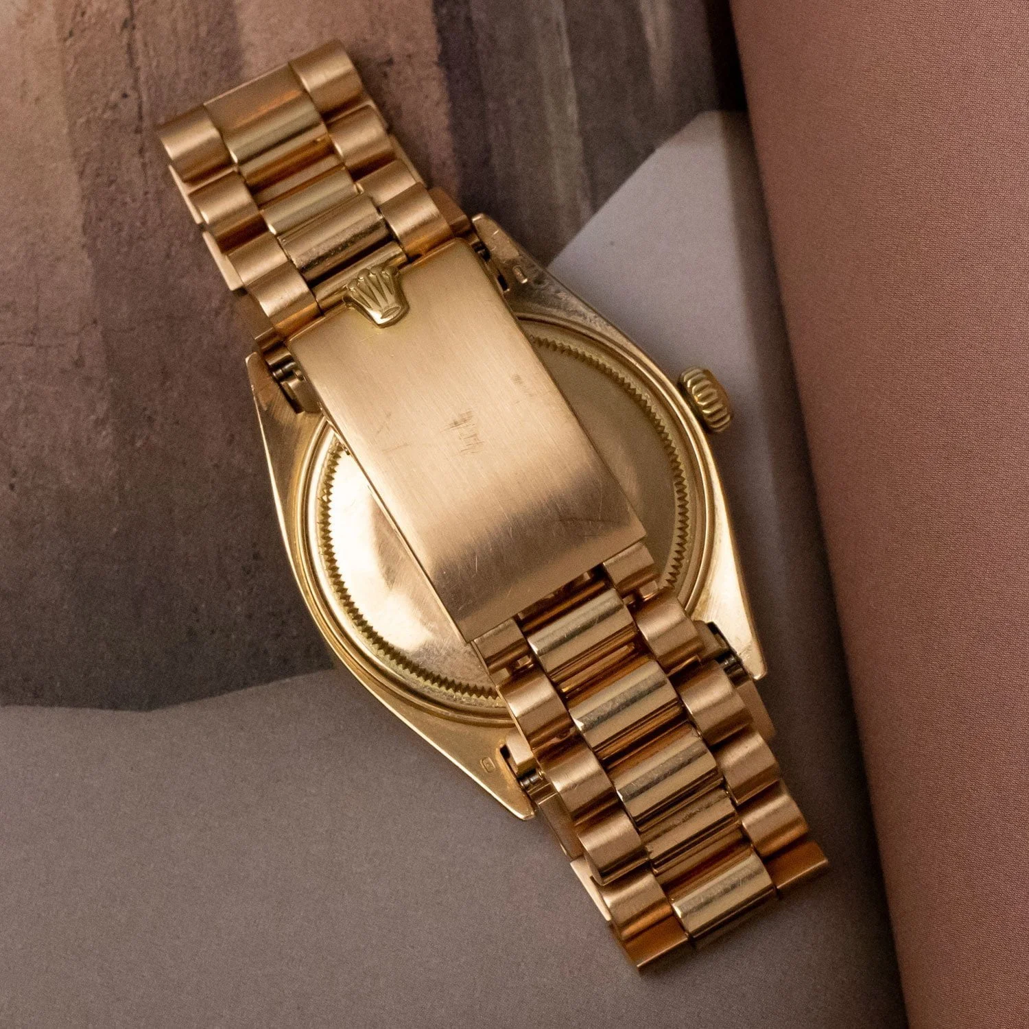 President bracelet and clasp shown with the rose-gold Datejust listing