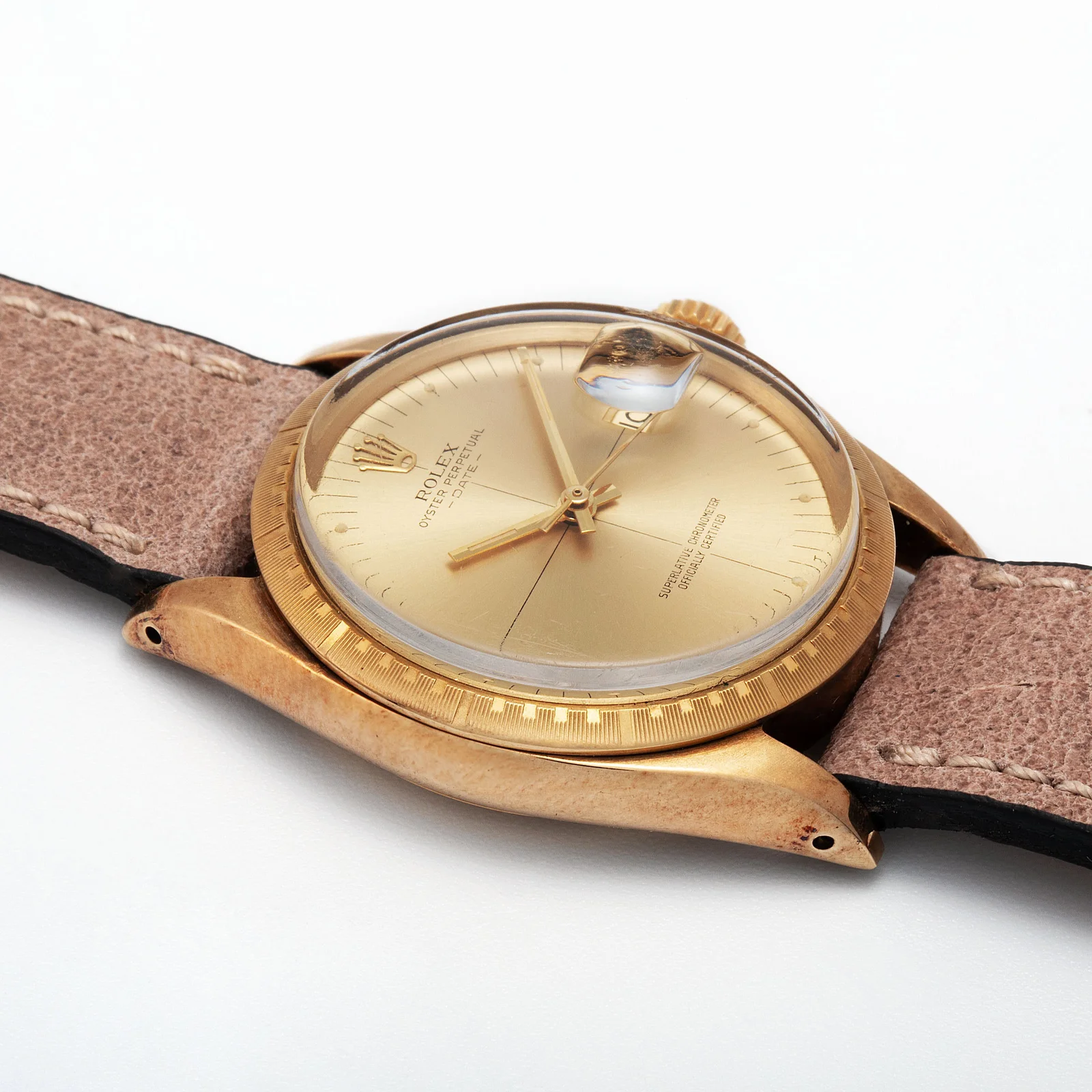 14K yellow-gold Rolex Oyster Perpetual Date ref. 1512 with champagne crosshair dial and patterned bezel