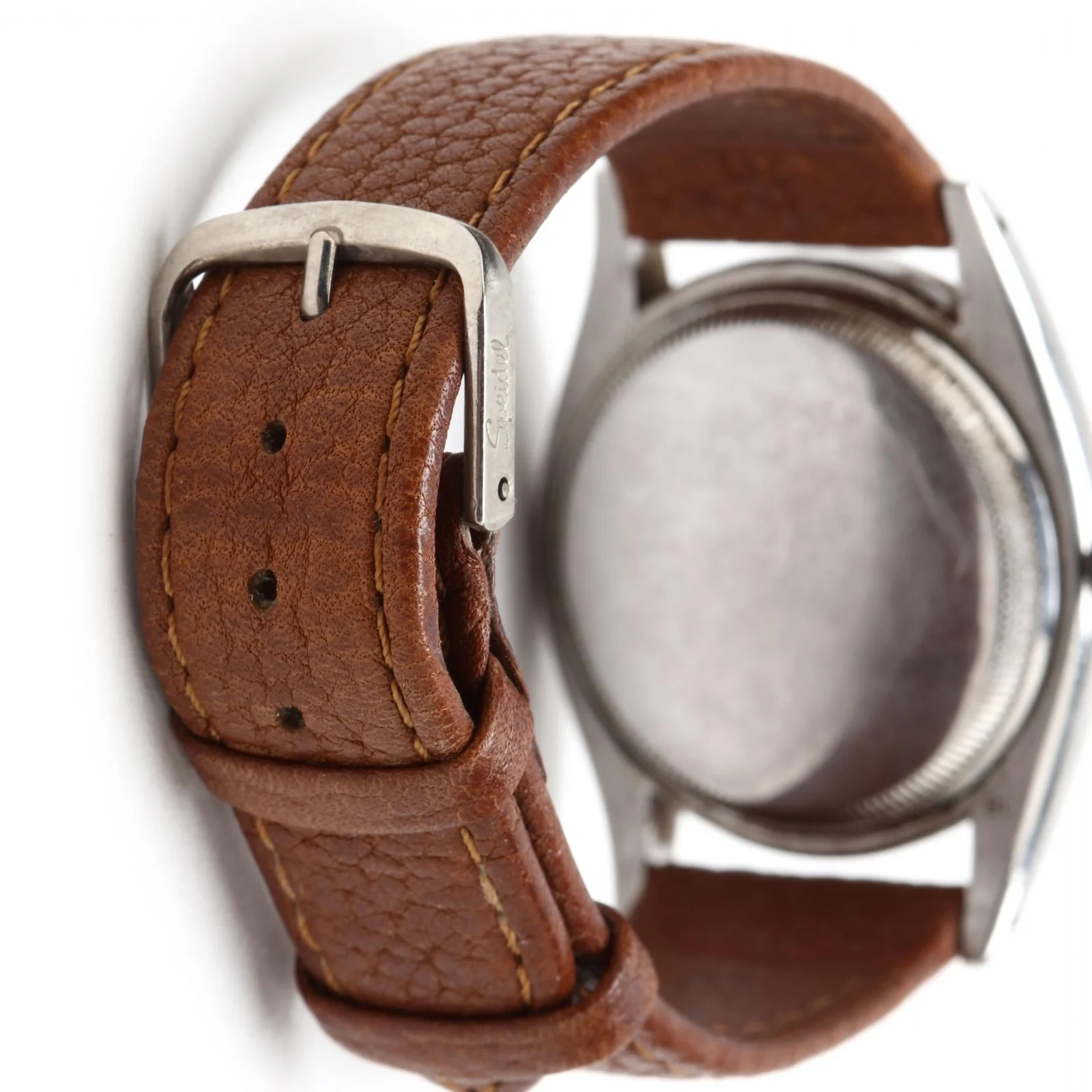 Leather strap and pin buckle fitted to the watch in Leland Little lot 3059