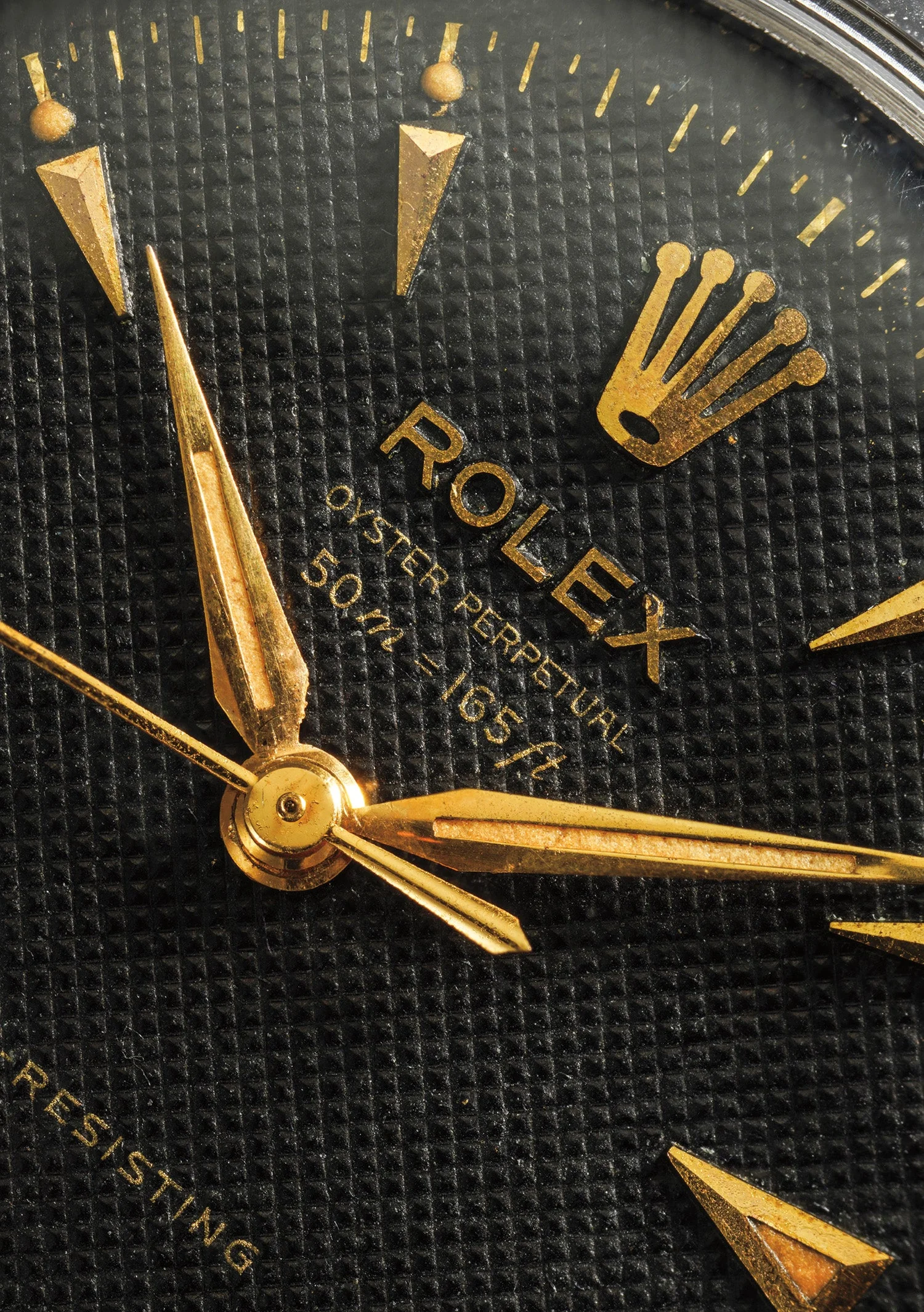 Close view of the black honeycomb dial, gilt markers, luminous plots, and red depth text on ref. 6352 case 28,524