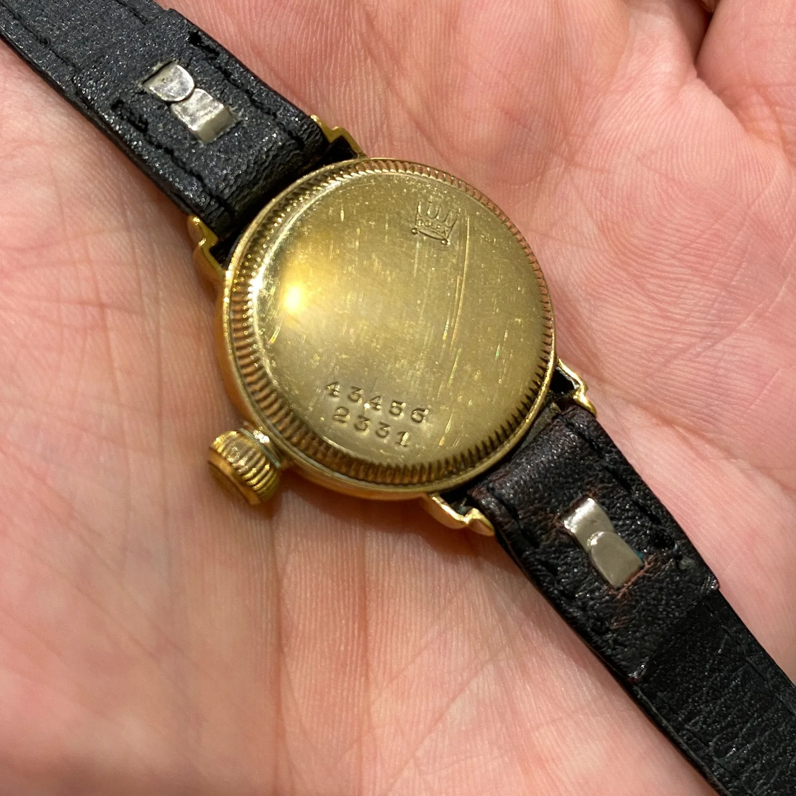 Caseback on a yellow-gold watch, with 34359 and 2331 visible