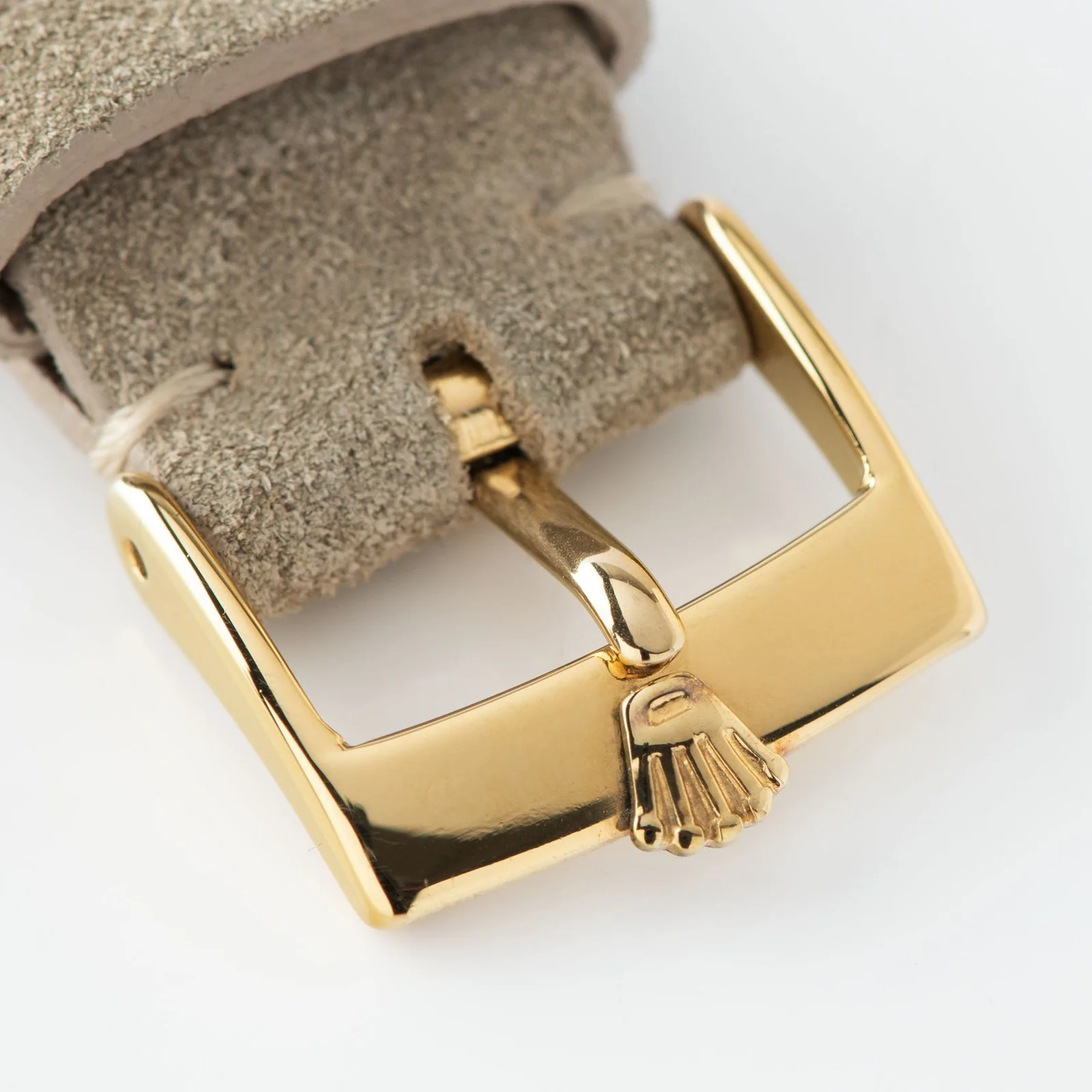 Gold Rolex plaque buckle on the strap shown with a Rolex ref. 1513